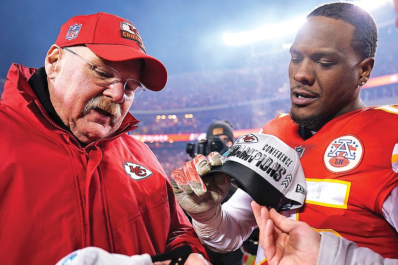 Chiefs coach Andy Reid talks with defensive end Frank Clark after Sunday night’s AFC Championship Game against the Bengals at Arrowhead Stadium in Kansas City. (Associated Press)