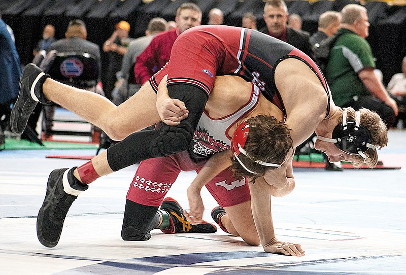 Jefferson City’s Eli Teiberis is lifted by Warrenton’s Noah Lohrmann during their fifth-place match at 126 pounds Saturday during the Class 3 boys wrestling state championships at Mizzou Arena in Columbia. (Kate Cassady/News Tribune)