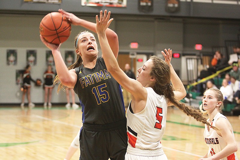 Fatima's Alli Robertson takes a shot against Owensville's Ella Gehlert during the second half of Thursday night's Class 4 District 10 Tournament semifinal game at Blair Oaks High School in Wardsville. (Greg Jackson/News Tribune)