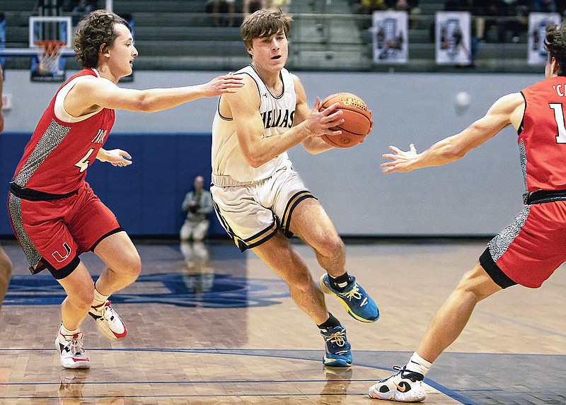 Jacob Rembecki of Helias splits the Union defense as he drives the ball through the lane during Wednesday night’s Class 5 District 5 Tournament first-round game at Capital City High School. (Josh Cobb/News Tribune)