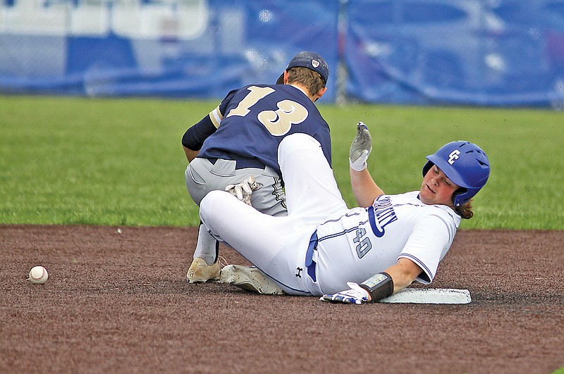Capital City’s Ben Turner holds onto the second-base bag, sliding in for a double during last season’s game against Helias at Capital City High School. (Greg Jackson/News Tribune)