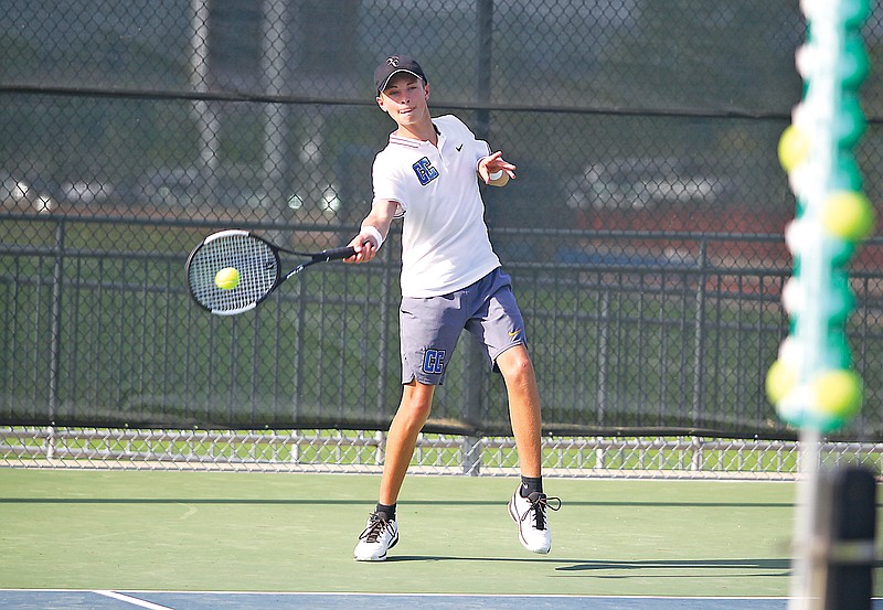 Capital City’s Ethan McNutt connects on a forehand shot during his doubles match against Helias in last season’s Class 2 District 5 Tournament championship dual at the Crusader Athletic Complex. (Greg Jackson/News Tribune)
