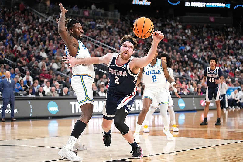 Gonzaga’s Drew Timme reaches for a loose ball against UCLA’s Kenneth Nwuba during Thursday’s West Region semifinal game in the men’s NCAA Tournament in Las Vegas. (Associated Press)