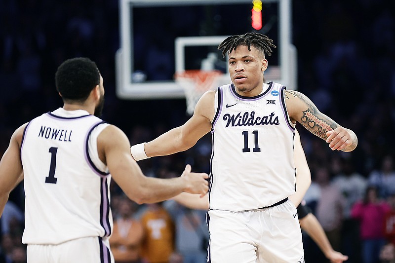 Kansas State forward Keyontae Johnson (right) is greeted by guard Markquis Nowell after a play in overtime of Thursday's East Region semifinal game against Michigan State in the NCAA tournament at Madison Square Garden in New York. (Associated Press)
