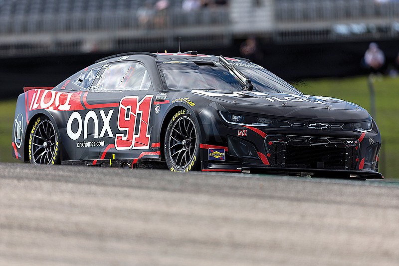 Kimi Raikkonen steers his car through Turn 1 during Saturday’s qualifying for the NASCAR Cup Series race at Circuit of the Americas in Austin, Texas. (Associated Press)