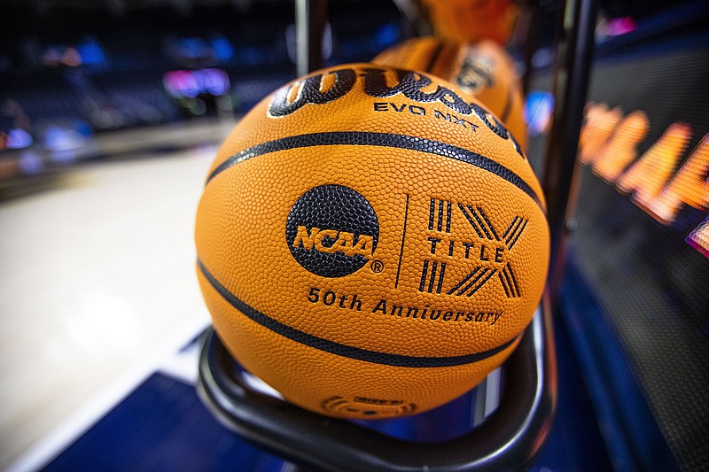 A basketball with an NCAA logo and a Title IX inscription rests on a rack before a First Four game between Illinois and Mississippi State at the women's NCAA Tournament earlier this month in South Bend, Ind. (Associated Press)