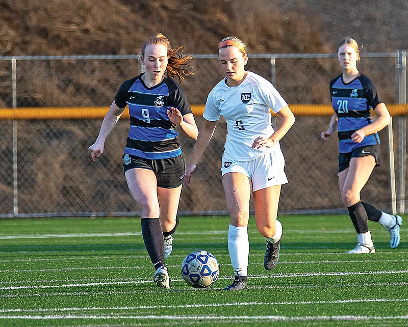 Rae Bohlken of Helias dribbles the ball past Capital City’s Kimber Noble during Wednesday night’s game at Capital City High School. (Josh Cobb/News Tribune)
