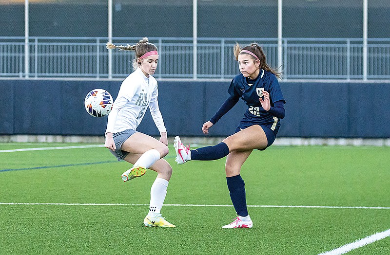 Reagan Schmitz of Helias kicks the ball around a Rolla player during Wednesday night’s game at the Crusader Athletic Complex. (Josh Cobb/News Tribune)