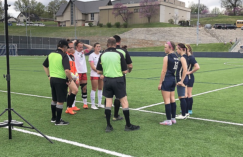 Captains for the Ozark Lady Tigers and the Helias Lady Crusaders meet at midfield prior to the start of Saturday's game in the Helias Shootout at the Crusader Athletic Complex. (Trevor Hahn/News Tribune)