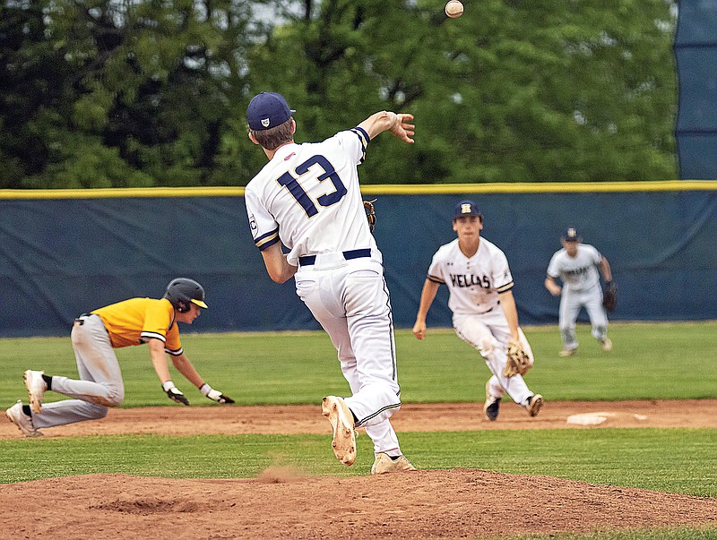 Helias pitcher Thorn Phillips turns and throws the ball to shortstop Myles Gresham on a pickoff attempt at second base during Thursday night’s game against Sedalia Smith-Cotton at the American Legion Post 5 Sports Complex. (Josh Cobb/News Tribune)