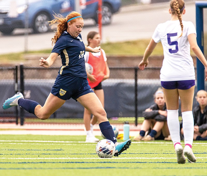 Lily Winegar of Helias kicks the ball away from Hickman’s Kira Hoenes during Thursday night’s match at the Crusader Athletic Complex. (Josh Cobb/News Tribune)