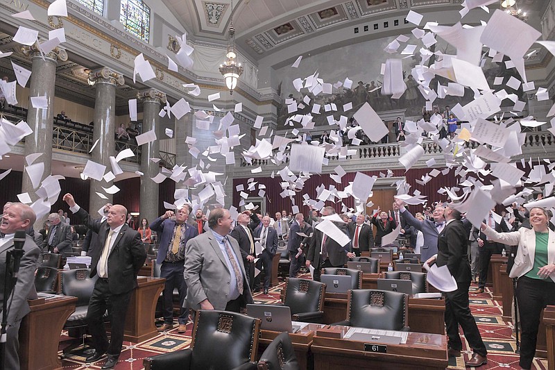 Members of the Missouri House of Representatives celebrate the conclusion of the first regular session of 102nd General Assembly with the traditional paper toss.