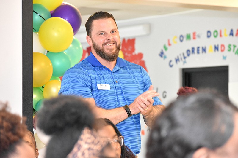 Explore Academy Principal Brad Bateman applauds the announcement that his school was selected national Star Academy Program of the Year on Wednesday at the school's cafeteria. (Pine Bluff Commercial/I.C. Murrell)