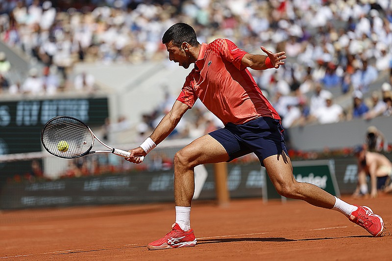 Novak Djokovic plays a shot against Karen Khachanov during Tuesday's quarterfinal match in the French Open at Roland Garros in Paris. (Associated Press)