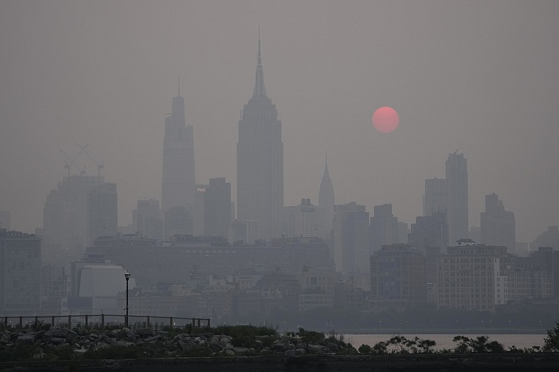 The sun rises over a hazy New York City skyline as seen from Jersey City, N.J., Wednesday, June 7, 2023. Intense Canadian wildfires are blanketing the northeastern U.S. in a dystopian haze, turning the air acrid, the sky yellowish gray and prompting warnings for vulnerable populations to stay inside. (AP Photo/Seth Wenig)