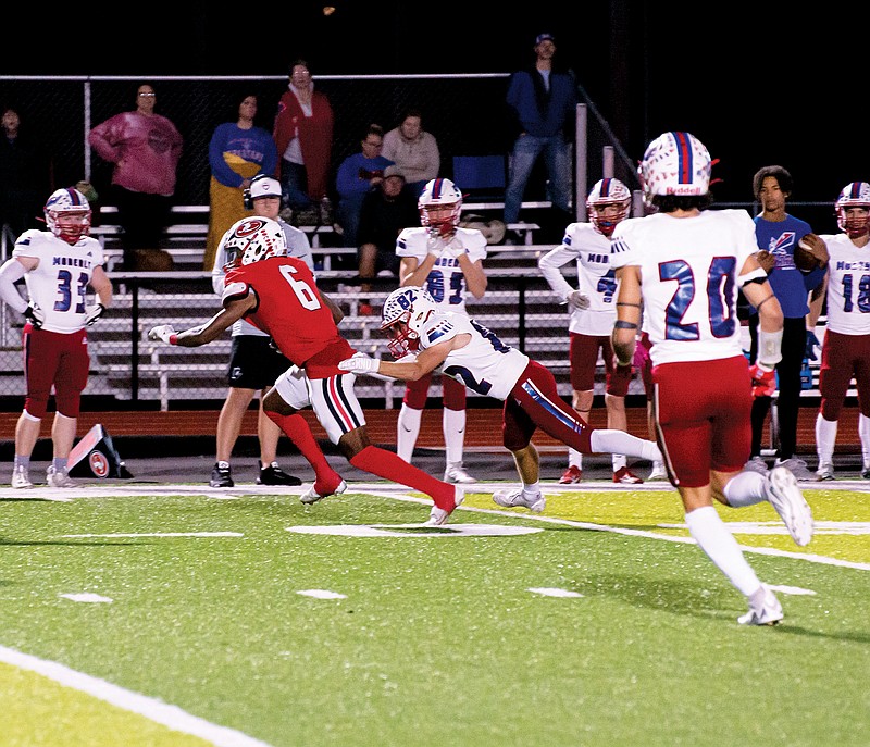 Jefferson City wide receiver Josh Wilson tries to elude a tackle by Moberly’s Tyler James during Friday night’s game at Adkins Stadium. (Ken Barnes/News Tribune)