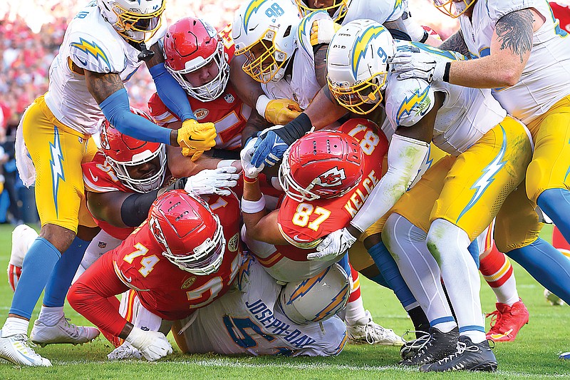 Chiefs tight end Travis Kelce (87) pushes across the goal line for a touchdown during the first half of Sunday’s game against the Chargers at Arrowhead Stadium in Kansas City. (Associated Press)
