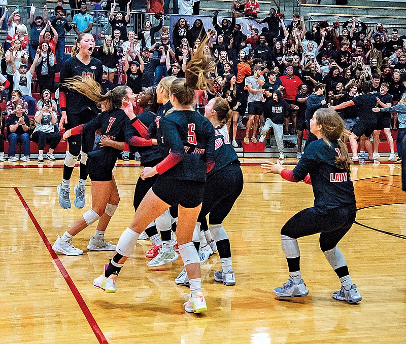 The Jefferson City Lady Jays celebrate after winning the final point of Tuesday night’s Class 4 District 5 Tournament championship match against Union at Fleming Fieldhouse. (Ken Barnes/News Tribune)
