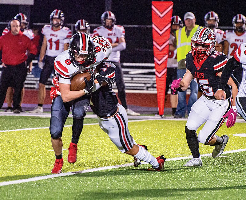 Jefferson City’s Anthony Seneker drags down Marshall’s Jaxson Case for a tackle during Friday’s Class 4 District 5 semifinal game at Adkins Stadium. (Ken Barnes/News Tribune)
