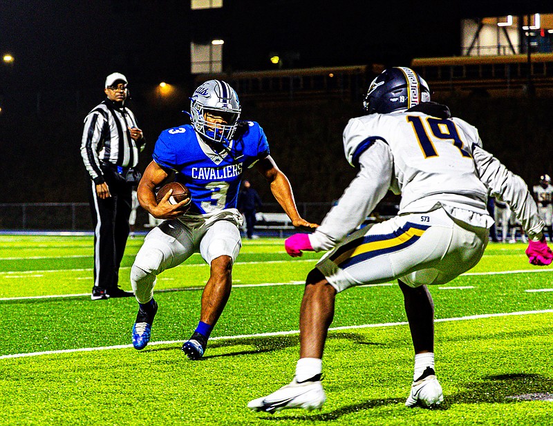 Capital City running back Jaylen Thomas tries to run past Battle's Daqual Wright during last month's district first-round game at Capital City High School. (Garrett Bradley/News Tribune)