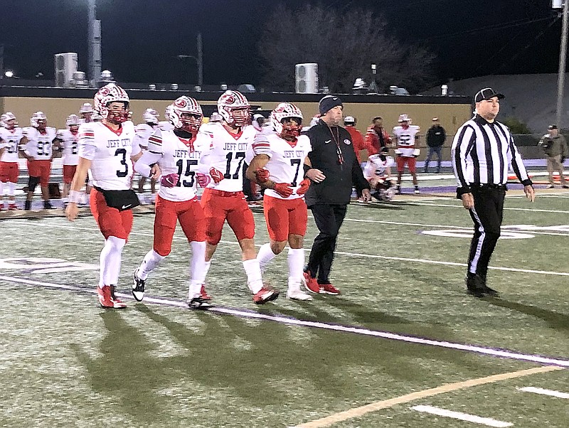 From left, Jefferson City captains Jacob Wilson, Kane Fuelling, Anthony Seneker and Jaiden LaViolette, along with head coach Damon Wells, may their way to midfield for the coin toss prior to the start of Friday night's Class 4 District 5 Tournament championship game at Pleasant Hill. (Trevor Hahn/News Tribune)