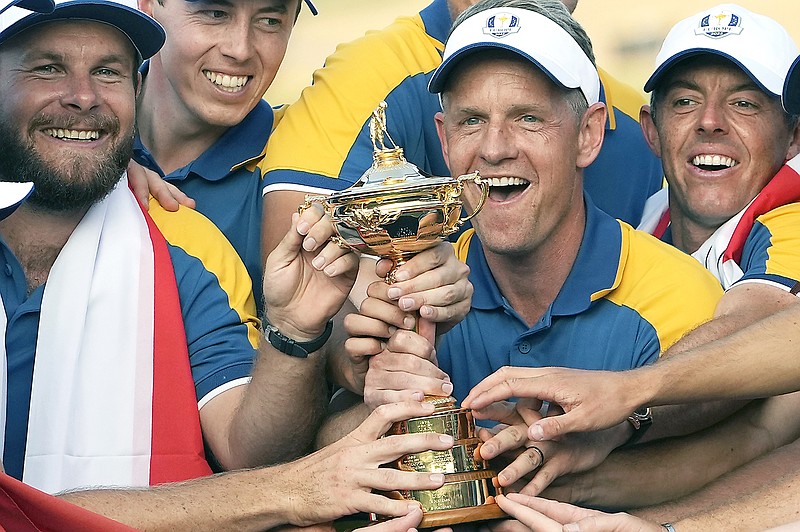 In this Oct. 1 file photo, Europe Team Captain Luke Donald (center) and team members lift the Ryder Cup after winning the trophy by defeating the United States at the Marco Simone Golf Club in Guidonia Montecelio, Italy. (Associated Press)
