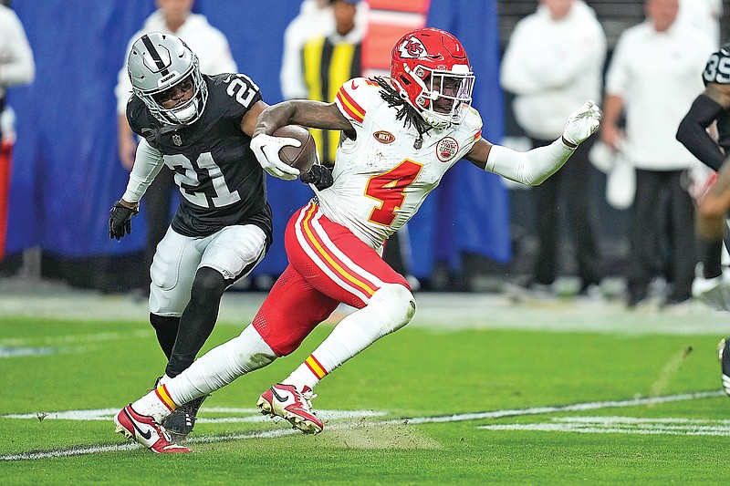 Chiefs wide receiver Rashee Rice runs with the ball past Raiders cornerback Amik Robertson during the second half of Sunday’s game in Las Vegas. (Associated Press