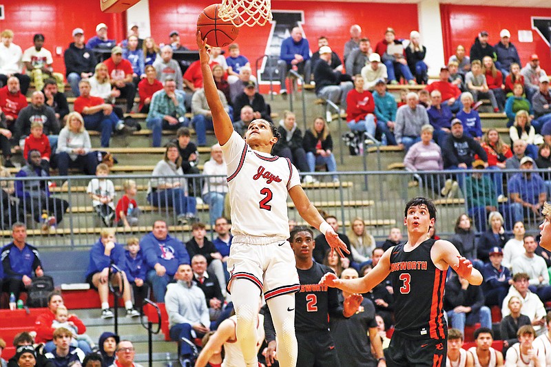 Jefferson City’s Kendric Johnson goes up for a layup as Ensworth School’s Louis O’Keefe (3) looks on during Wednesday’s first-round game of the Joe Machens Great 8 Classic at Fleming Fieldhouse. (Jason Strickland/News Tribune)