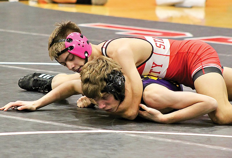Jefferson City’s Dominic Stafford wrestles against Hickman’s Jason Hager during their 126-pound match in Wednesday night’s dual at Fleming Fieldhouse. (Alex Pfeiffer/News Tribune)