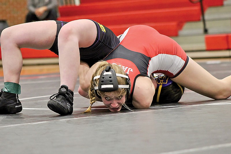 Jefferson City’s Kaylee Redcay holds down Hickman’s Addy Bruce on the mat for a pin during their 135-pound match in Wednesday night’s Central Missouri Activities Conference dual at Fleming Fieldhouse. (Alex Pfeiffer/News Tribune)