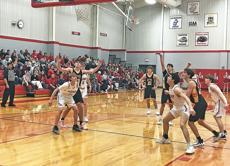 Players from Calvary Lutheran and Bunceton/Prairie Home watch in anticipation as a free-throw attempt heads toward the basket during Friday night's game at Calvary Lutheran High School. (Greg Jackson/News Tribune
