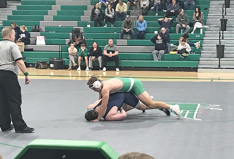 Cole Peters of Blair Oaks works to move Father Tolton's Evan Tollenaar onto his back for a pin during their 285-pound match in Tuesday night's tri-dual at Blair Oaks High School. (Greg Jackson/News Tribune)