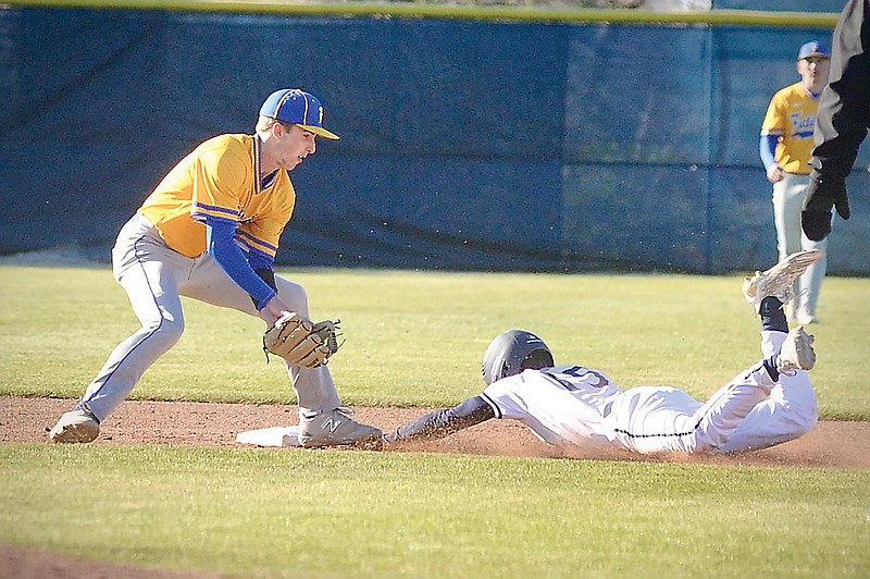 CJ Howell of Helias steals second base ahead of the tag by Fatima second baseman Max Stuecken during Monday night’s game at the American Legion Post 5 Sports Complex. (Shaun Zimmerman/News Tribune)