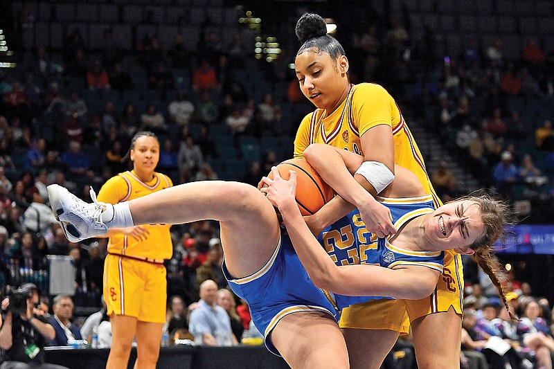 Southern California guard JuJu Watkins and UCLA forward Gabriela Jaquez wrestle for the ball during the second half of a Pac-12 Conference Tournament semifinal game earlier this month in Las Vegas. (Associated Press)