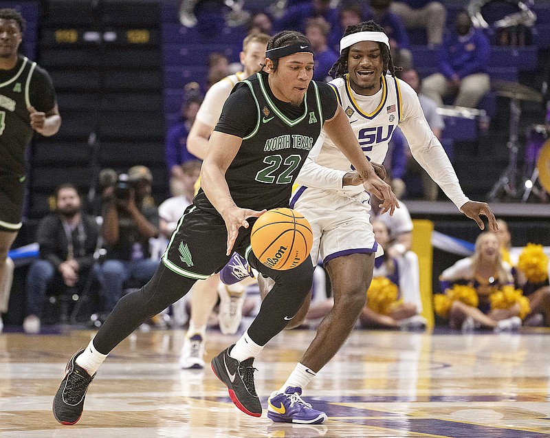 North Texas guard CJ Noland drives the ball down the court past LSU forward Mwani Wilkinson after the steal  in the first half of last week's NIT first-round game in Baton Rouge, La. (Hilary Scheinuk/The Advocate via the Associated Press)