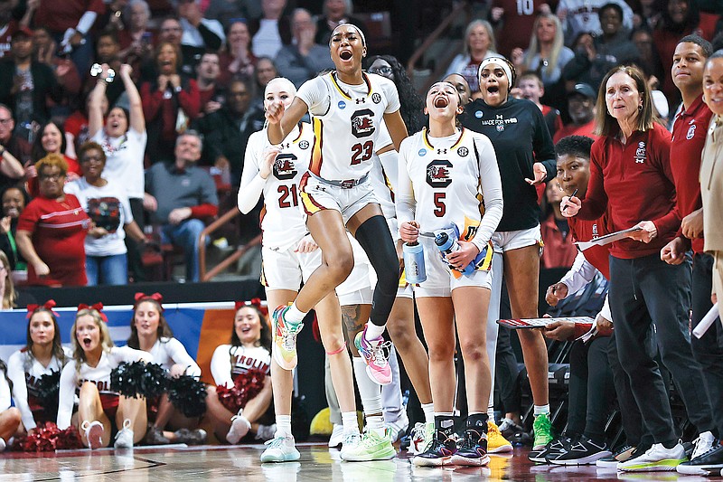 South Carolina forward Chloe Kitts (21), guard Bree Hall (23) and guard Tessa Johnson (5) react as the Gamecocks score against North Carolina during the first half of Sunday’s second-round women’s NCAA Tournament game in Columbia, S.C. (Associated Press)