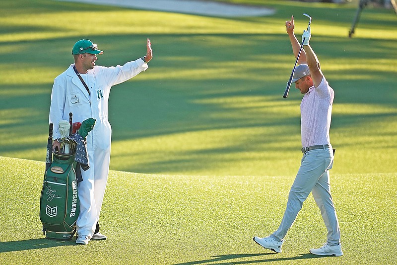 Bryson DeChambeau celebrates after chipping in for a birdie on the 18th hole during Saturday’s third round of the Masters at Augusta National Golf Club in Augusta, Ga. (Associated Press)