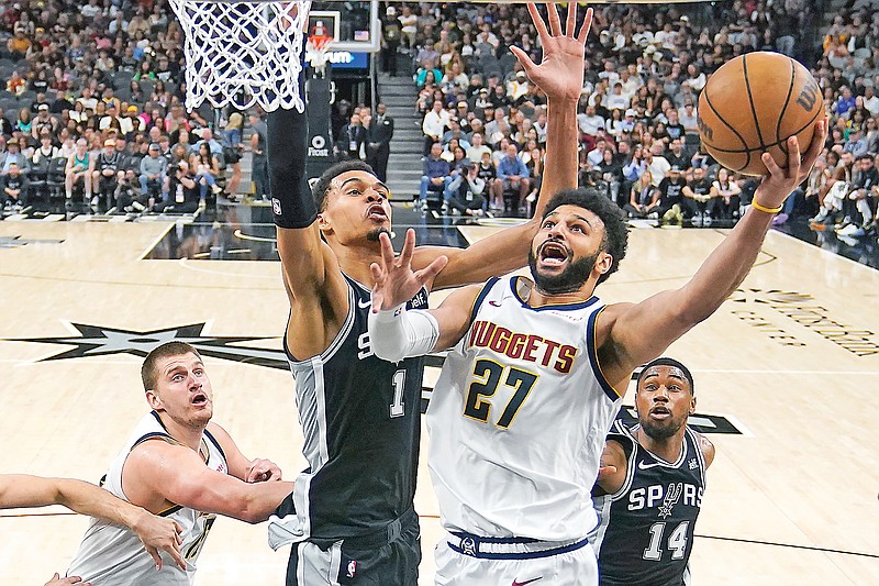 Nuggets guard Jamal Murray drives to the basket against Spurs center Victor Wembanyama during the first half of Friday night’s game in San Antonio. (Associated Press)