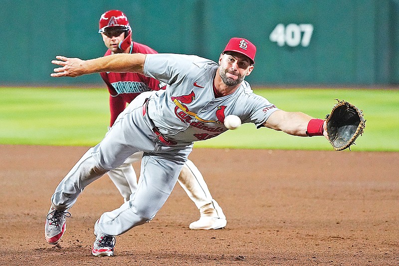 Cardinals first baseman Paul Goldschmidt dives in vain for a ball hit by Joc Pederson as Diamondbacks teammate Christian Walker (background) looks on during the fifth inning of Sunday afternoon’s game in Phoenix. (Associated Press)