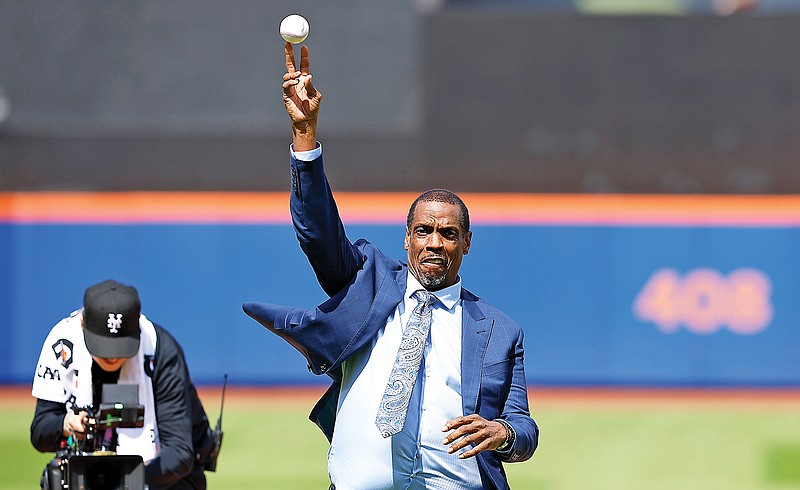 Former Mets pitcher Dwight Gooden throws out the ceremonial first pitch before Sunday afternoon’s game against the Royals at Citi Field in New York. (Associated Press)