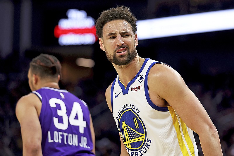Warriors guard Klay Thompson reacts after making a 3-point basket during the first half of Sunday's game against the Jazz in San Francisco. (Associated Press)