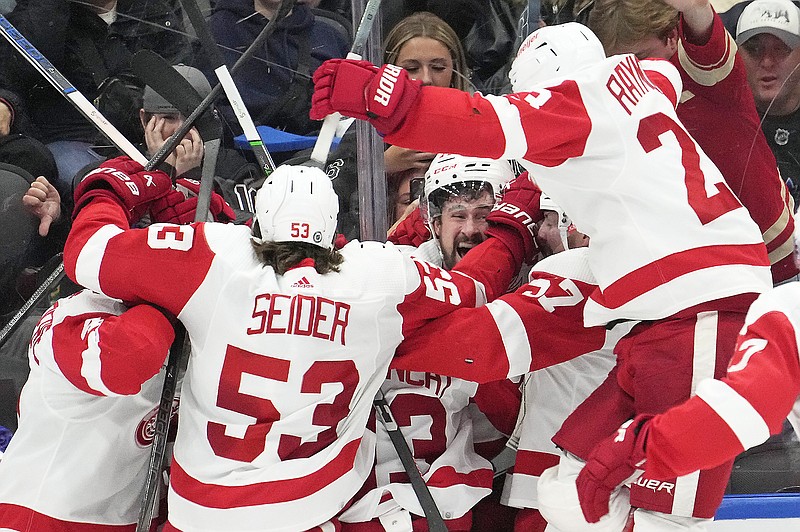 Red Wings center Dylan Larkin (background) celebrates with teammates after scoring a goal in overtime of Saturday's game against the Maple Leafs in Toronto. (Frank Gunn/The Canadian Press via the Associated Press)