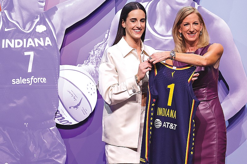 Iowa’s Caitlin Clark poses for a photo with WNBA commissioner Cathy Engelbert after being selected first overall by the Indiana Fever during the first round of the WNBA Draft on Monday night in New York. (Associated Press)