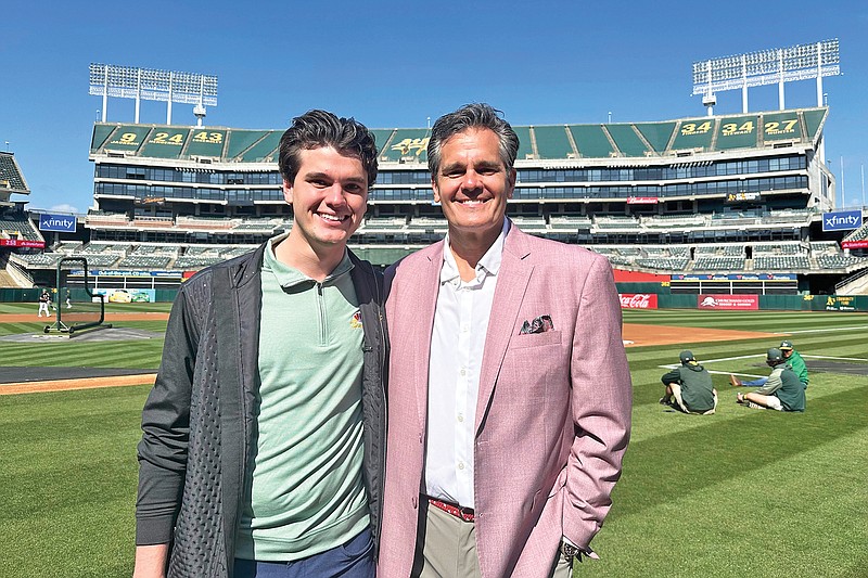 Athletics broadcaster Chris Caray (left) and his father, Chip, the play-by-play announcer for the Cardinals, stand for a photo before the teams’ game Monday in Oakland, Calif. (Associated Press)