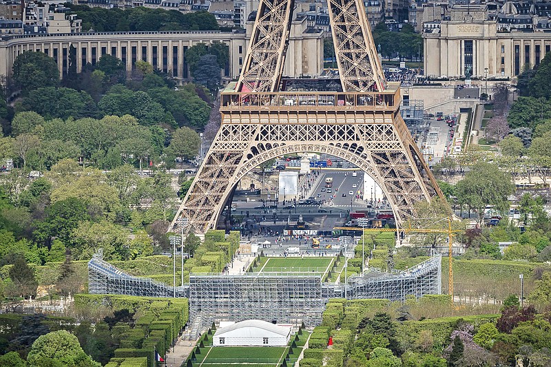 Stands are under construction on the Champ-de-Mars (foreground) with the Eiffel Tower in background Monday in Paris. The Champ-de-Mars will host the beach volleyball and blind football at the Paris 2024 Olympic and Paralympic Games. (Associated Press)