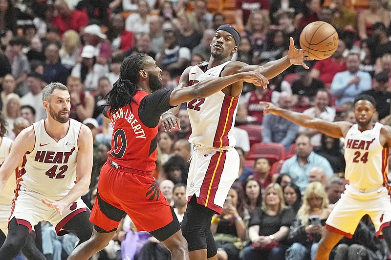 Heat forward Jimmy Butler blocks a pass by Raptors guard Javon Freeman-Liberty during the first half of Friday's game in Miami. (Associated Press)