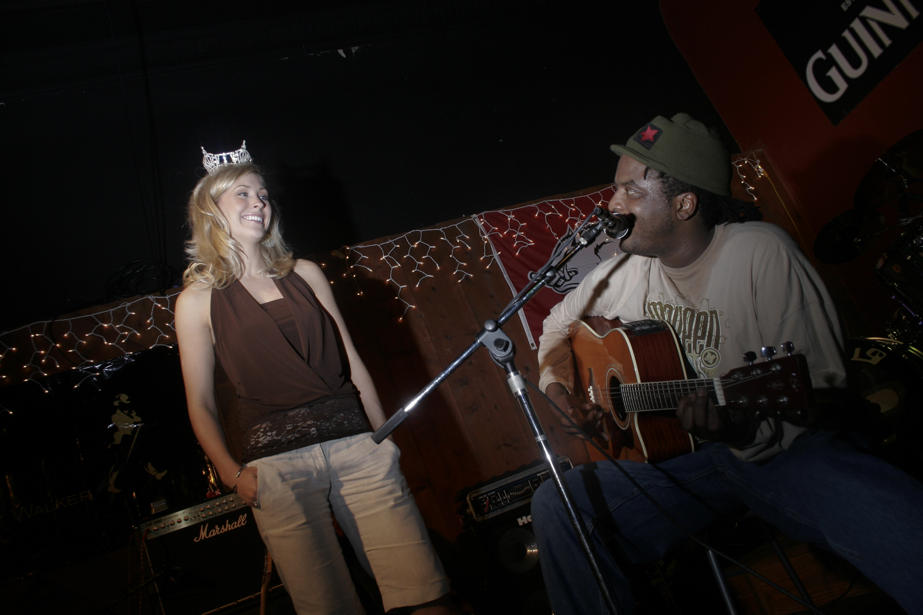 Musician Louscious Spiller talks with Miss Arkansas Amber Bennett onstage during a fundraiser for Special Olympics held at the Cornerstone Pub in North Little Rock Thursday.