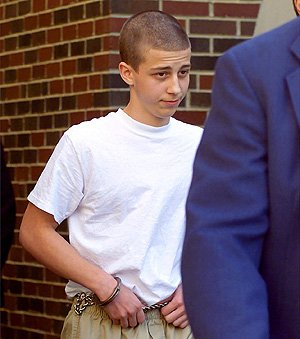 Convicted Westside Middle School shooter Andrew Golden, then 13, is escorted from a back door of the Craighead County Courthouse in Jonesboro in this April 2000 photo.