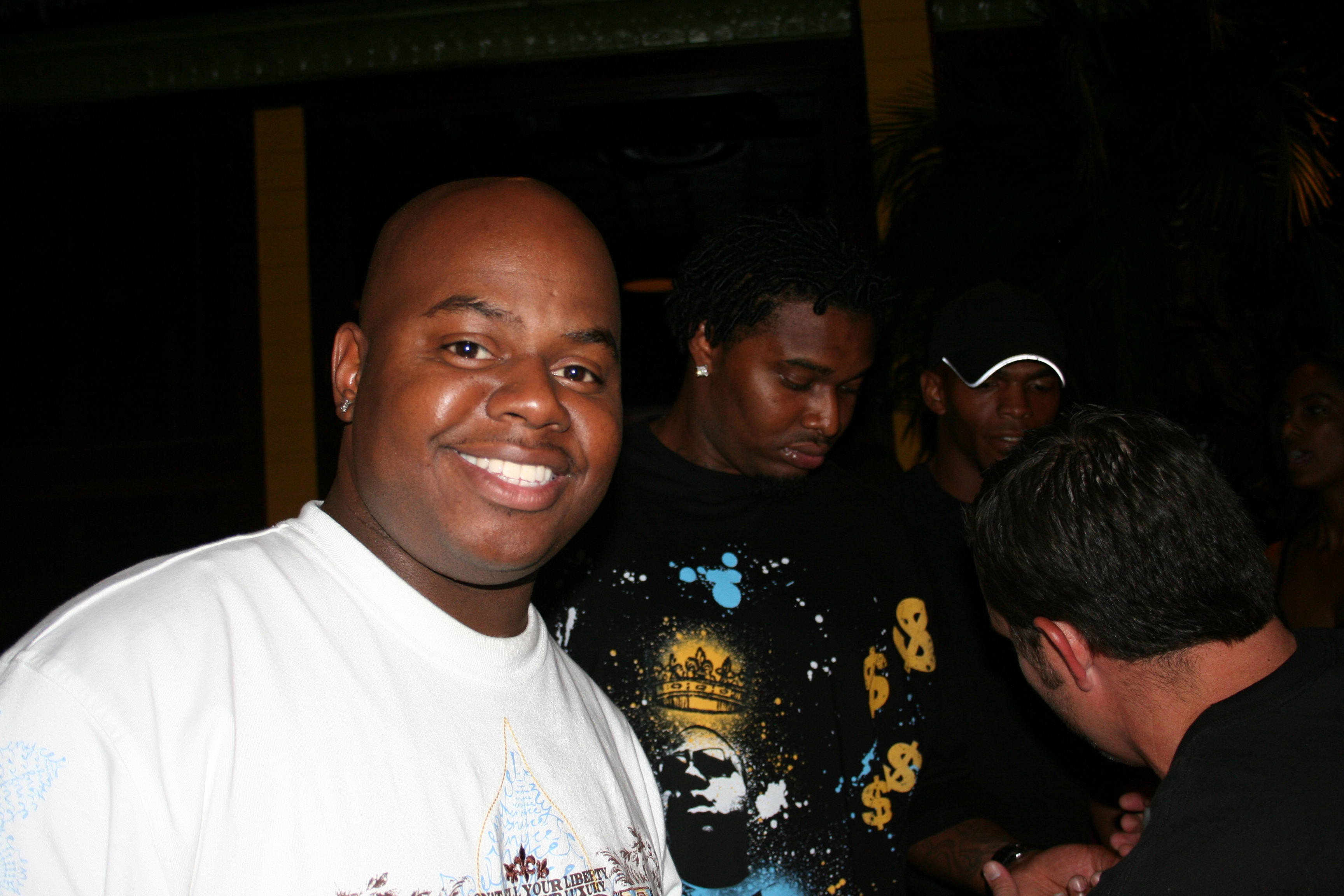 A Cajun's goer smiles as he waits from friends to go inside