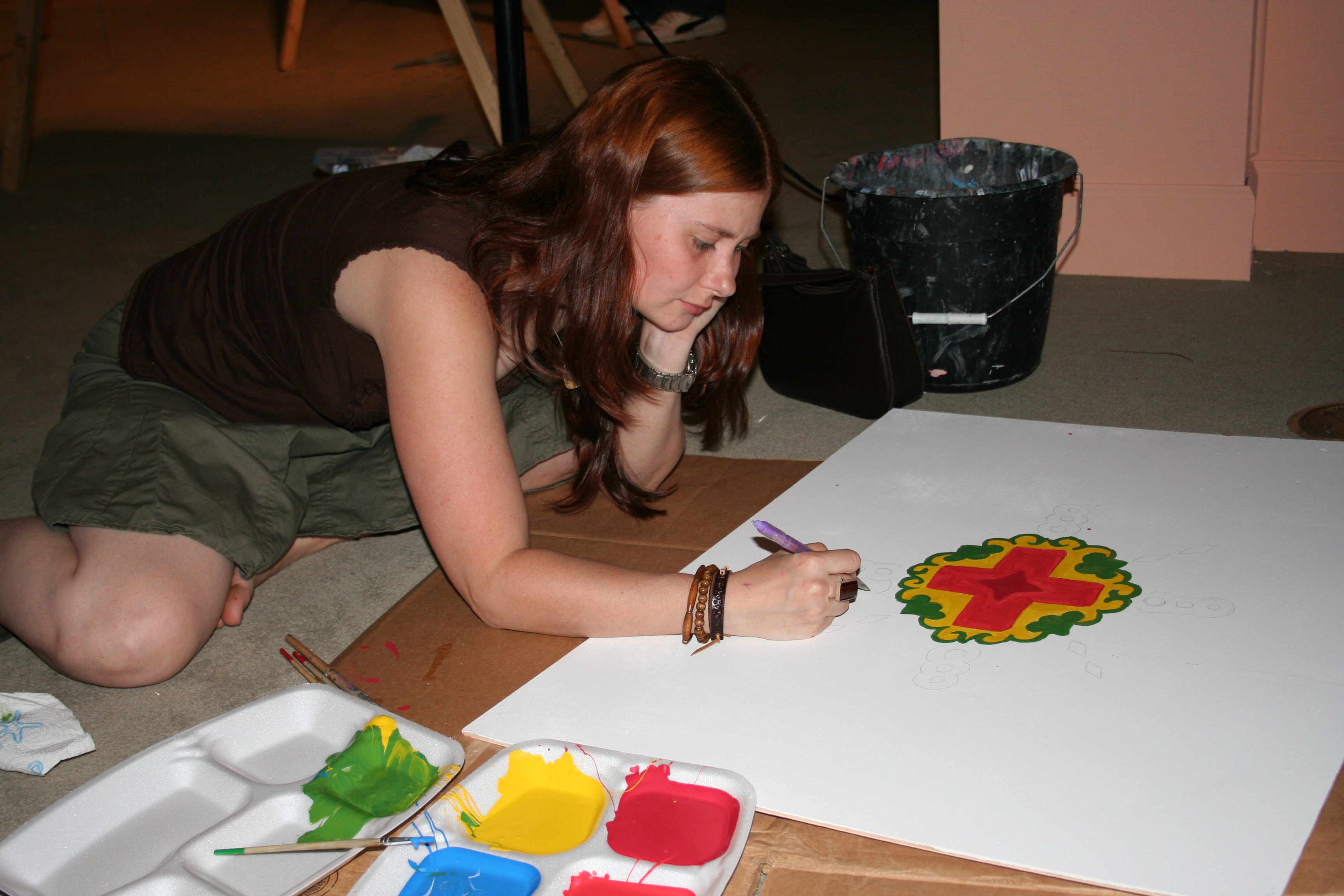 Elizabeth James works on a painting at ArtsScene